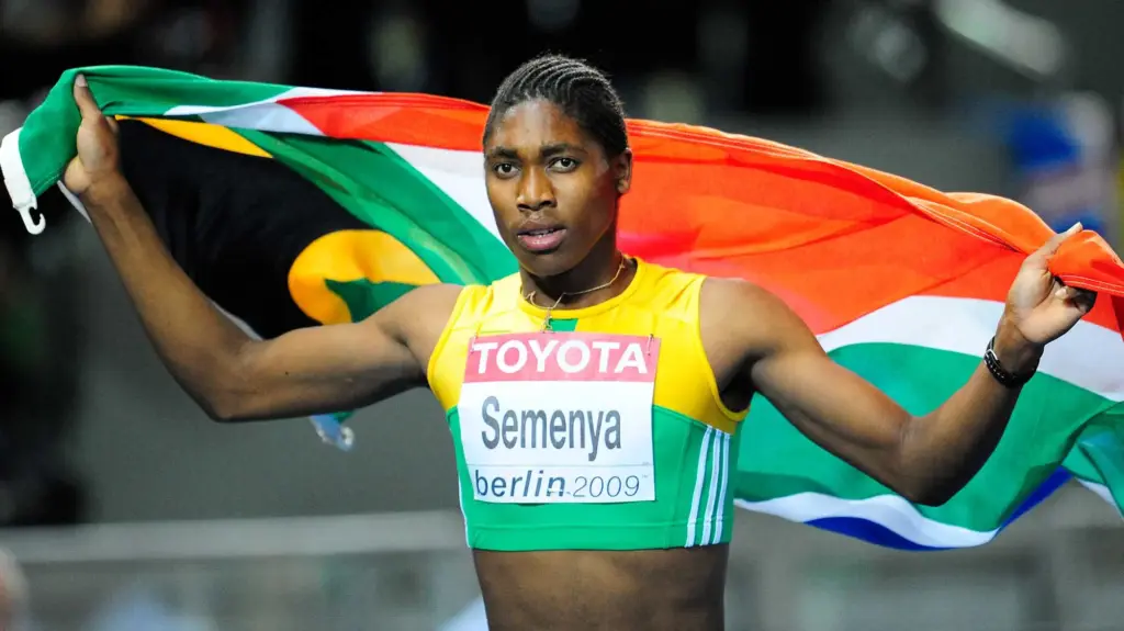 South African runner Caster Semenya holding a South African flag after a race