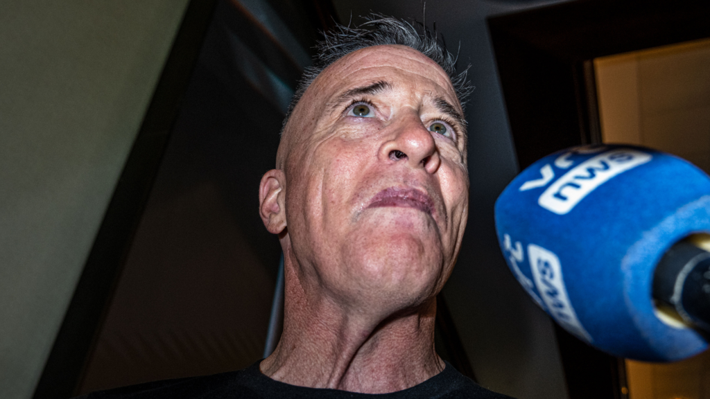 Greg Bovino speaks into a microphone.