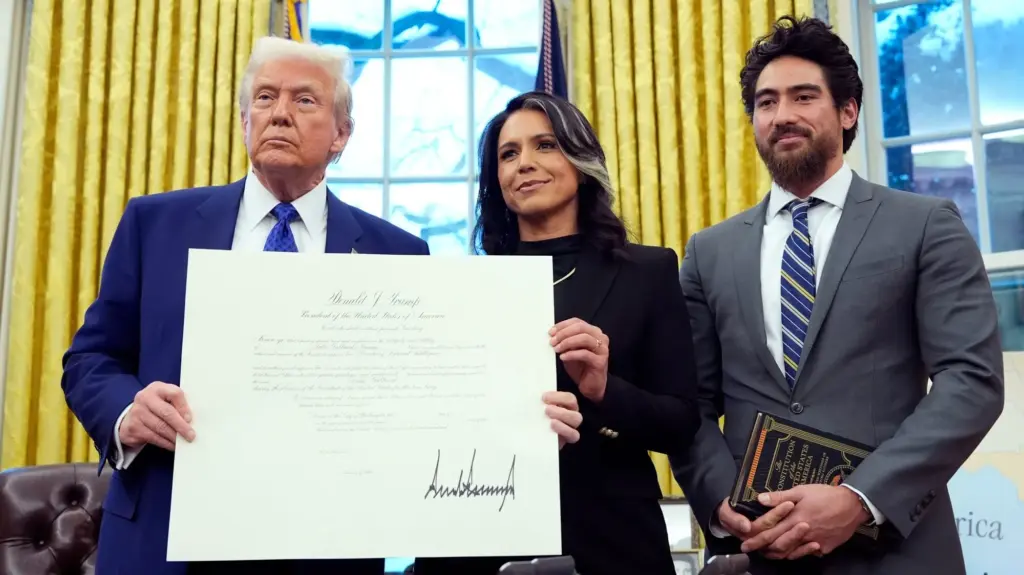 Tulsi Gabbard, Donald Trump, and Gabbard's husband Abraham stand together in the Oval Office during her swearing in.