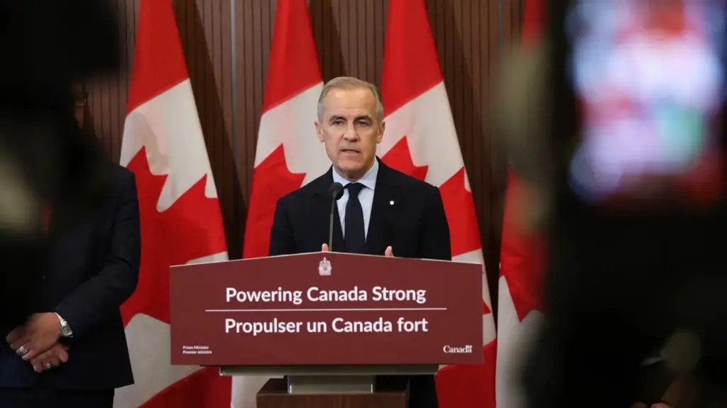 Canadian Prime Minister Mark Carney speaks at a podium labeled with the text 