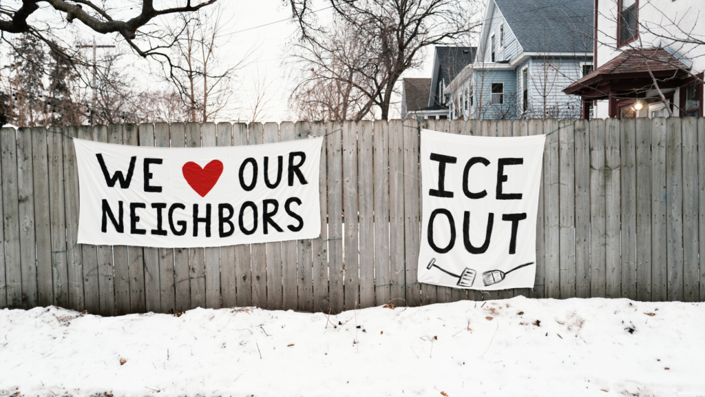 signs say 'we heart our neighbors' and 'ice out.'