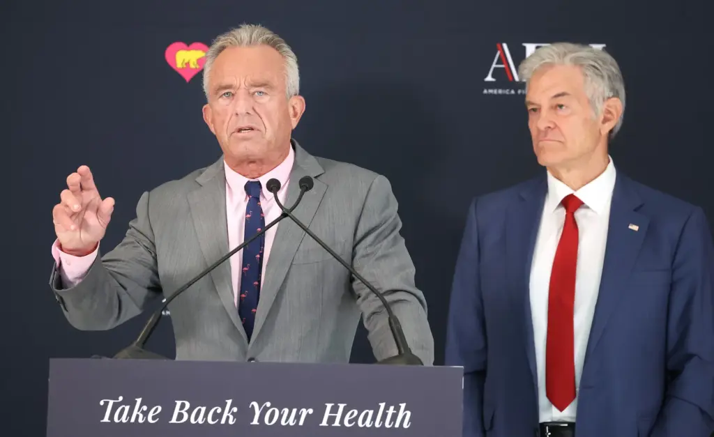 RFK Junior and Mehmet Oz at a podium that says