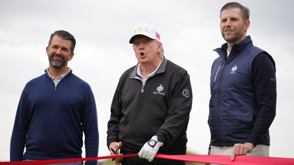 U.S. President Donald Trump speaks next to Donald Trump Jr. (L) and Eric Trump as they attend the ribbon-cutting ceremony at a new 18-hole course at Trump International Golf Links on July 29, 2025 in Balmedie, near Aberdeen, Scotland.