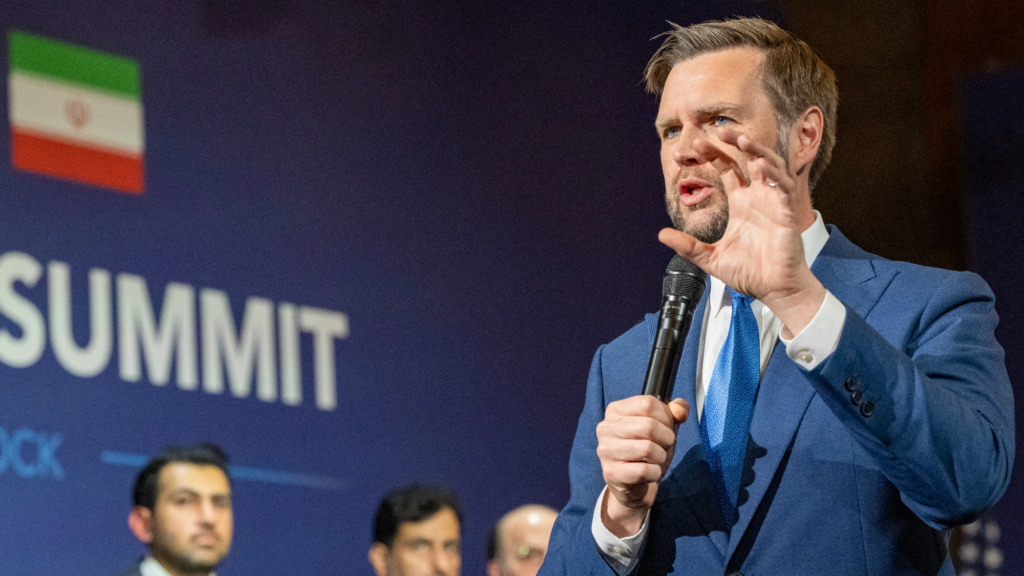 JD Vance holding a microphone.