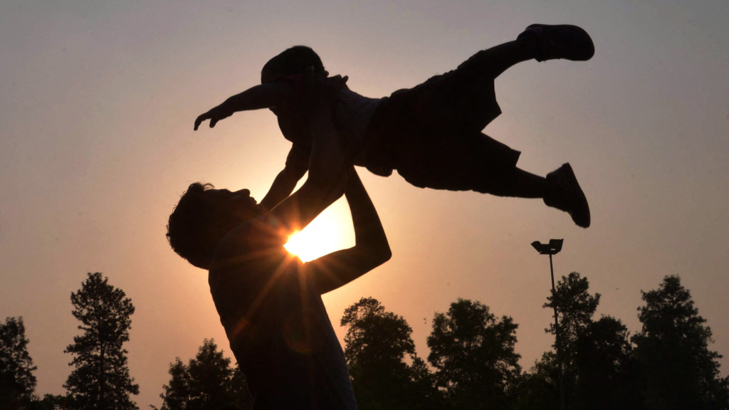 father holds child