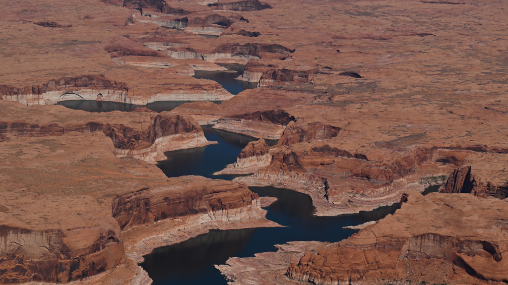 A river winds between red rock.