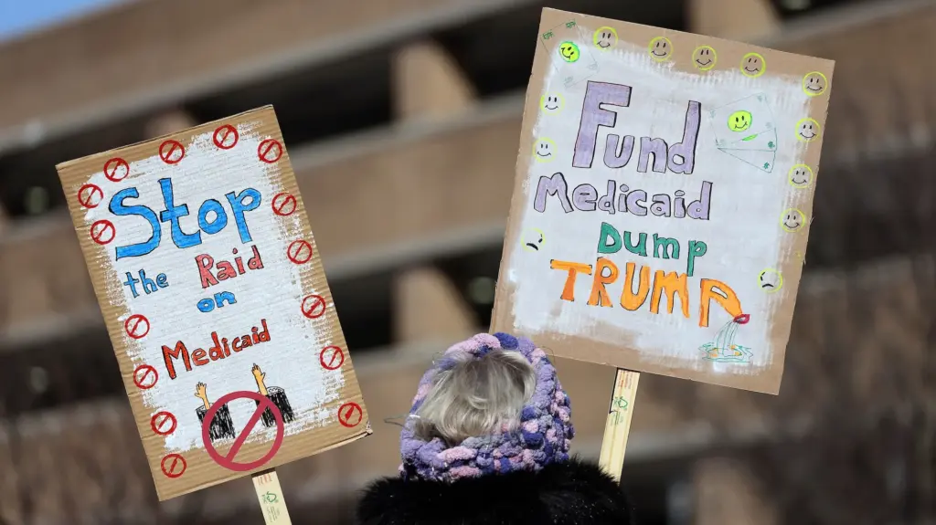 A person holding up signs that say 
