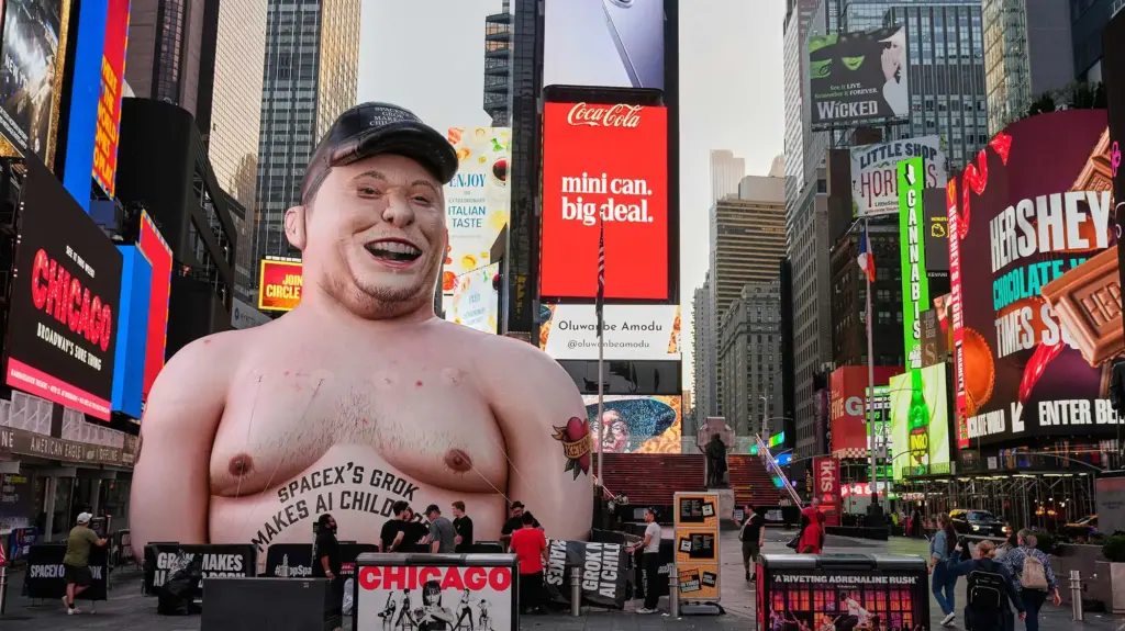 A shirtless Elon Musk inflatable in the middle of Times Square.