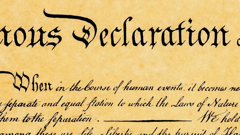 A macro close-up of handwritten text in elegant cursive script on aged, textured beige parchment paper. At the top, the words