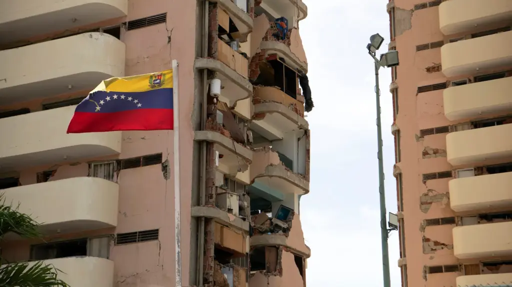 Building structures destroyed by the earhquake with a Venezulan flag up front.