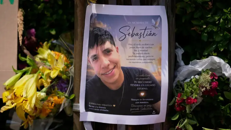 A poster of Joan Sebastián Durán Guerrero, the man killed by US Immigration and Customs Enforcement, is displayed among yellow flowers at a makeshift memorial in Biddeford, Maine.