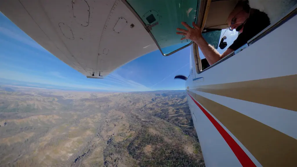 View from outside of a small airplane flying over Lassen National Forest.