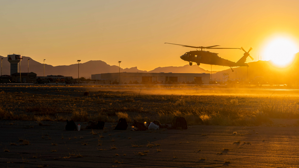 a helicopter lands at sunset