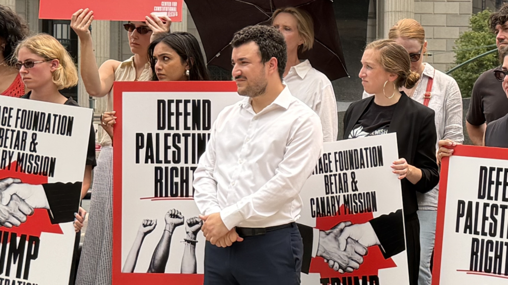 Mahmoud Khalil stands with supporters.