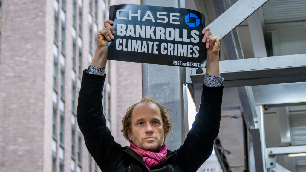 Man holds sign that reads 