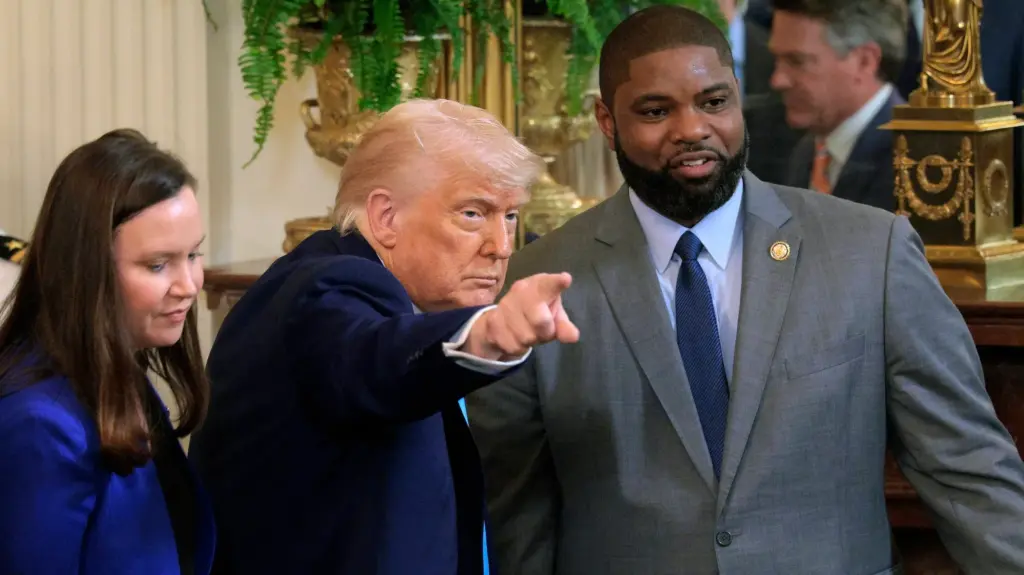 Left to right: Ashley Moody, a white woman in a blue suit, Donald Trump, and Byron Donalds, a Black man in a gray suit.