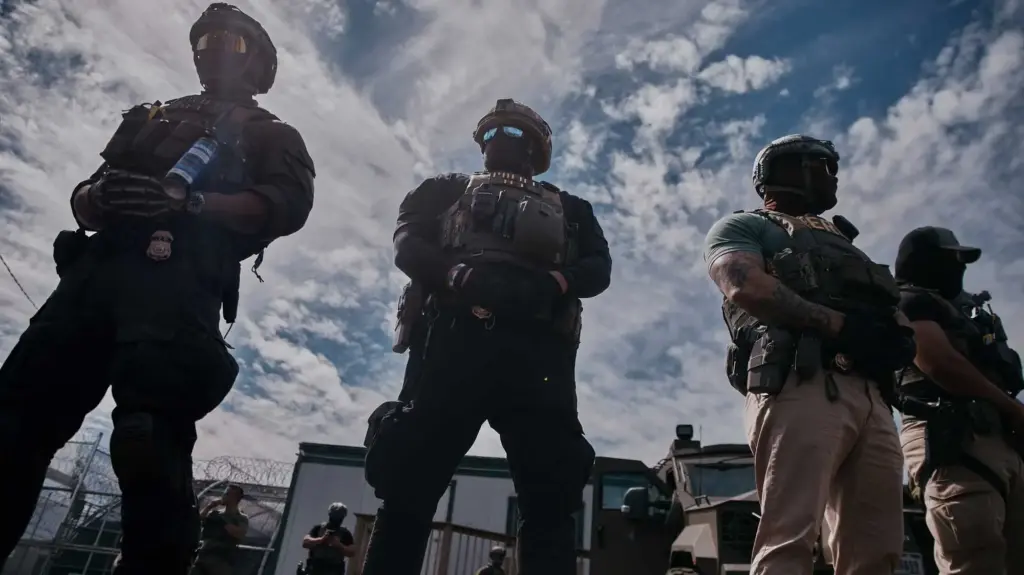 Three masked ICE agents stand side by side.