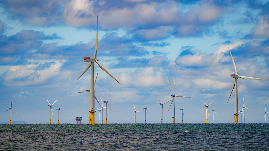 Yellow wind turbines shoot out of the sea.