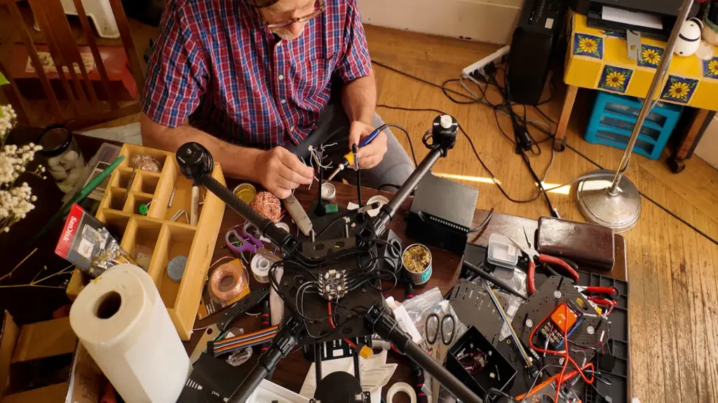 Reporter Matt Smith solders drone parts on his dining room table.