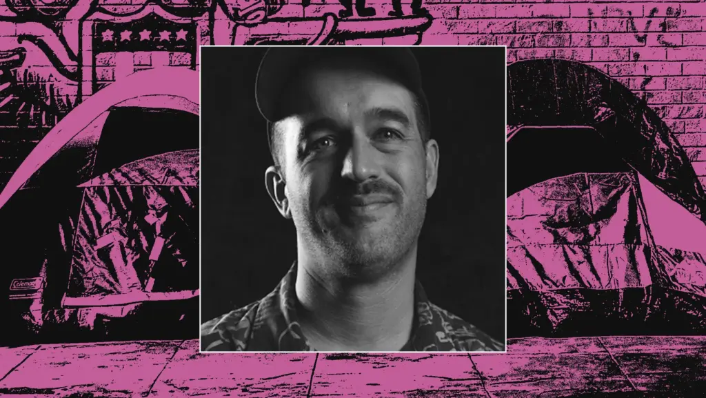 Black-and-white portrait of a smiling man in a baseball cap, superimposed on a high-contrast magenta and black illustration of tents on a city sidewalk.