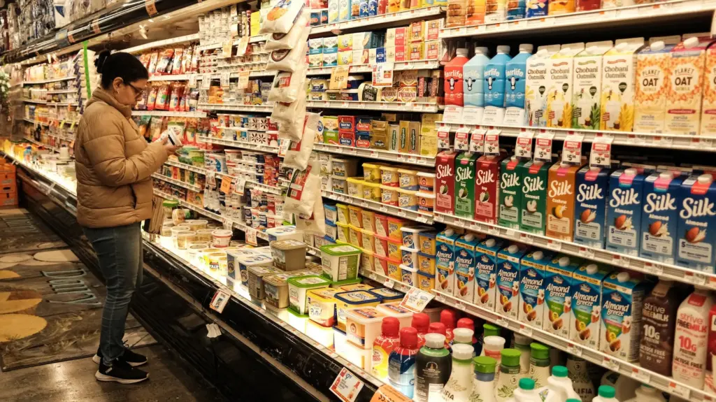 A woman shops for dairy products at a local supermarket in the Sugar Hill neighborhood of the Manhattan borough of New York City on April 9, 2026.