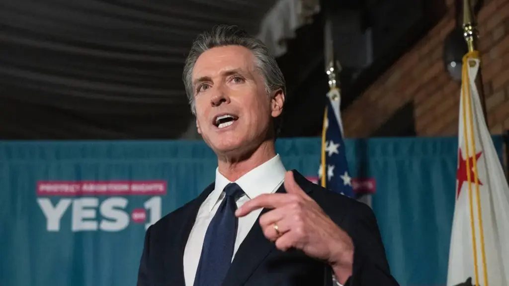 Gavin Newsom gesturing with his hands as he speaks.