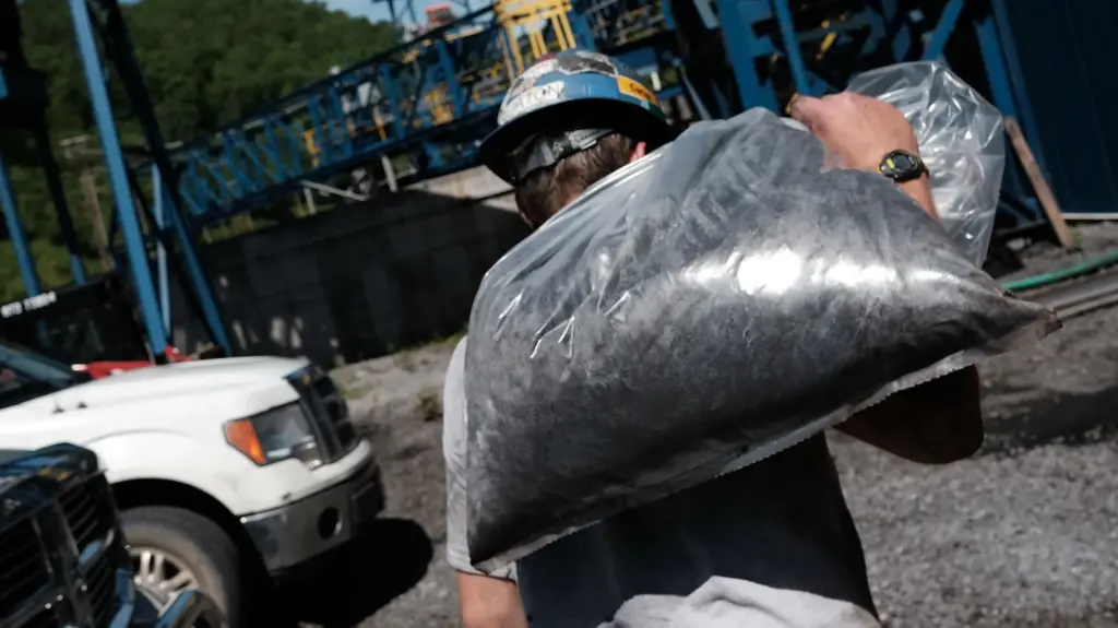 A man takes coal samples at a coal prep plant outside the city of Welch, West Virginia.