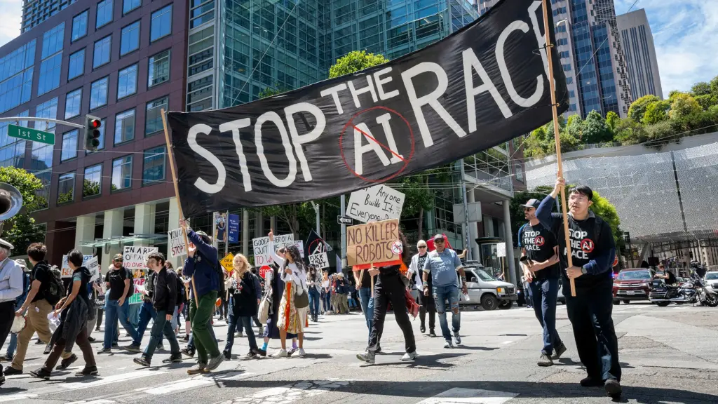 A group of demonstrators outside offices in San Francisco hold signs protesting the use of AI.
