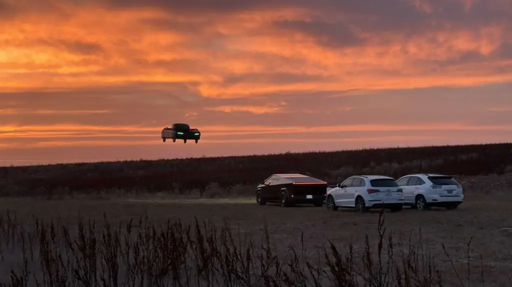 A car flying over a Cybertrcuk and two other cars.