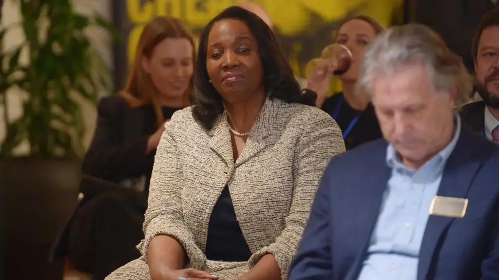 Lisa Cook seated, with a pensive look on her face