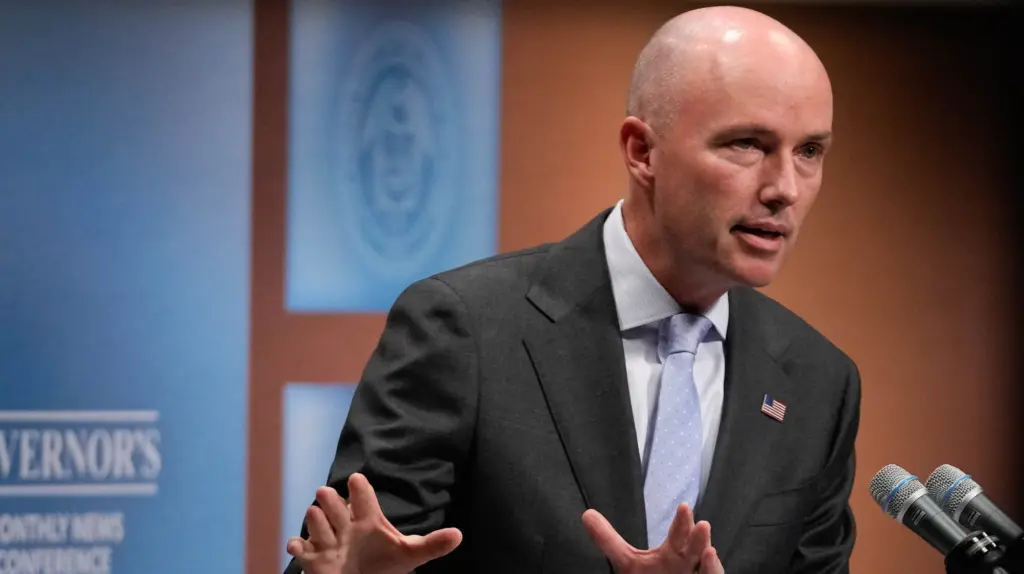 Utah Gov. Spencer Cox at a podium.