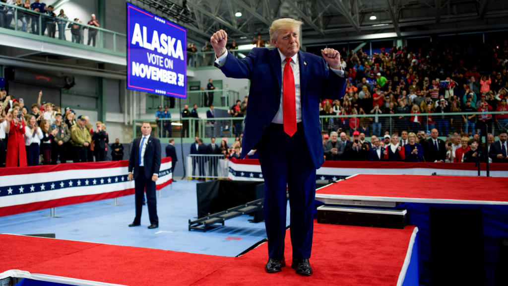 Trump dances in front of a sign urging people in Alaska to vote for him.